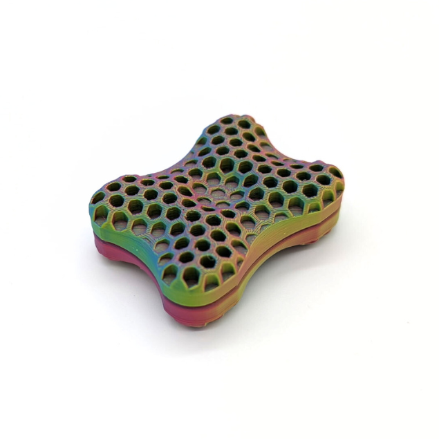Colorful honeycomb-patterned object on a white background